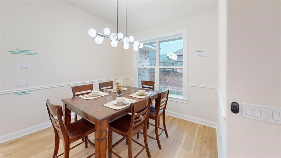 Dining area with light wood-style flooring and baseboards