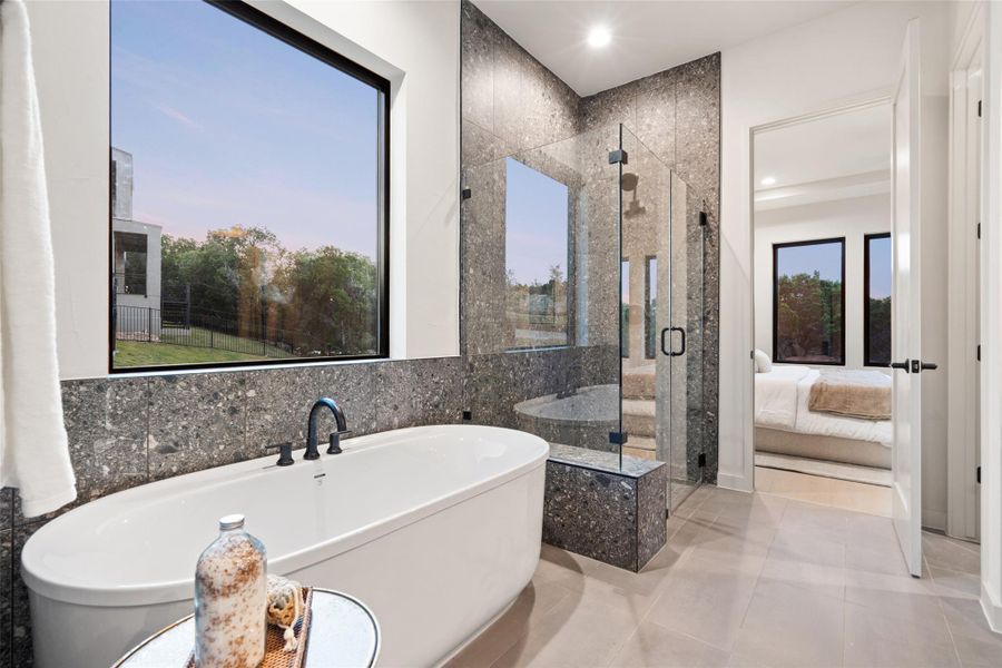 A deep soaking tub and a spacious glass-enclosed shower create a spa-like retreat. A deep soaking tub and a spacious glass-enclosed shower create a spa-like retreat.