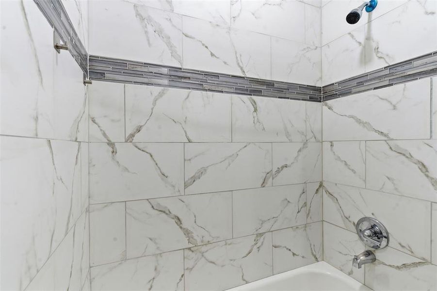 Full bathroom featuring shower / bath combination Full bathroom featuring shower / bath combination