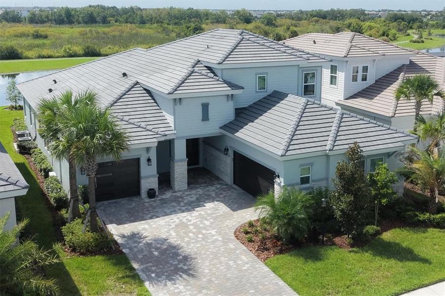Front exterior of a new home in Star Farms at Lakewood Ranch, Lakewood Ranch, FL, highlighting curb appeal (Image 21). Front exterior of a new home in Star Farms at Lakewood Ranch, Lakewood Ranch, FL, highlighting curb appeal (Image 21).