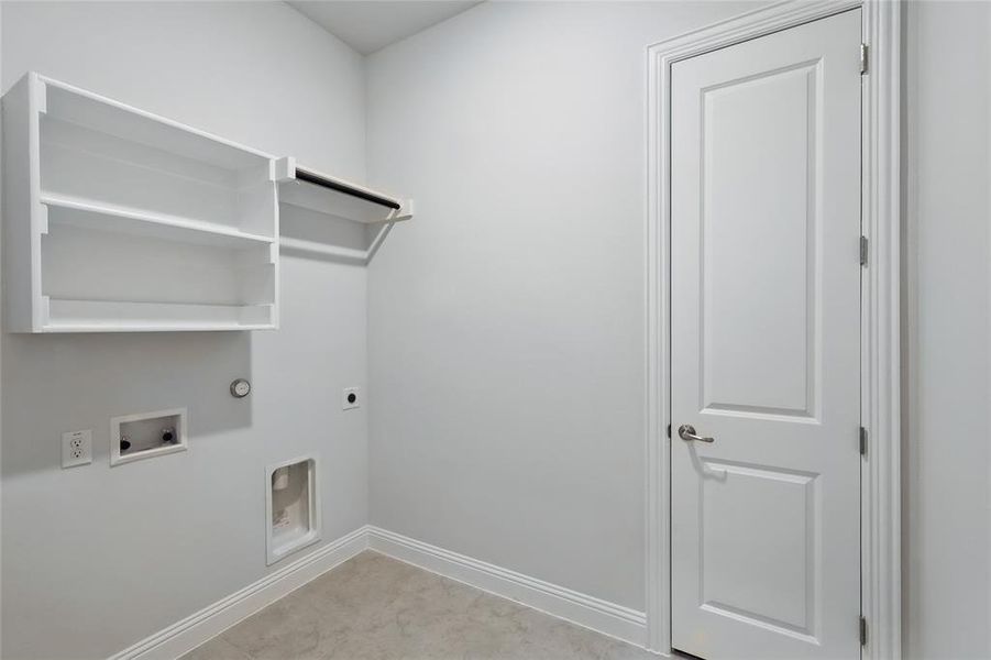Washroom with gas dryer hookup, hookup for an electric dryer, hookup for a washing machine, and baseboards Washroom with gas dryer hookup, hookup for an electric dryer, hookup for a washing machine, and baseboards