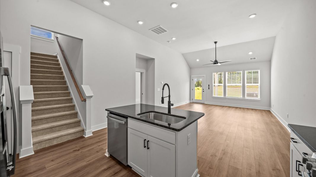 Elegant and compact island anchors this tasteful kitchen with high standards and timeless appeal