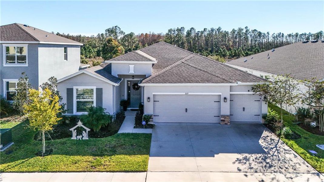 Front exterior of a new home in Deerbrook, Land O' Lakes, FL, highlighting curb appeal (Image 22). Front exterior of a new home in Deerbrook, Land O' Lakes, FL, highlighting curb appeal (Image 22).
