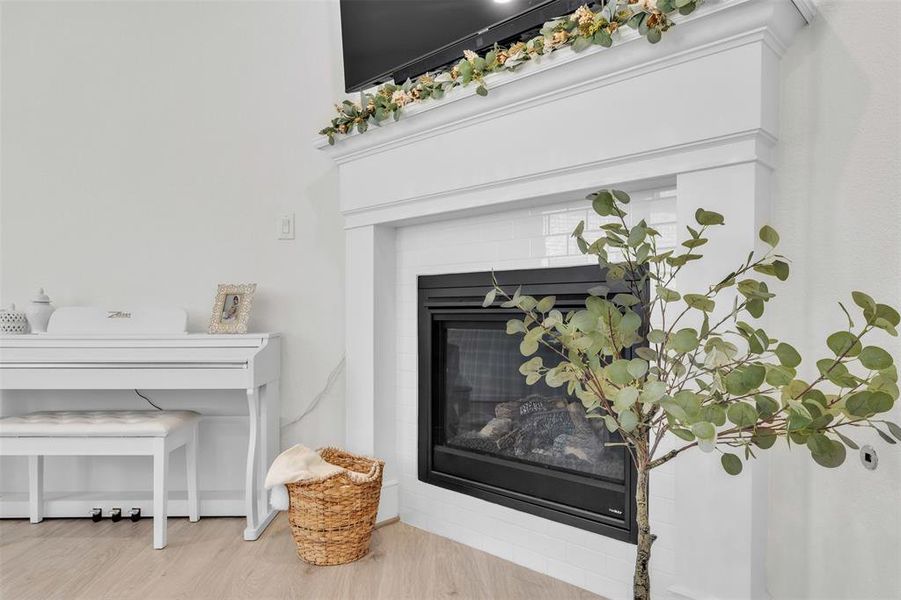 Built-in fireplace with a white mantel and surround, complemented by light wood-finish flooring and white wall finishes Built-in fireplace with a white mantel and surround, complemented by light wood-finish flooring and white wall finishes
