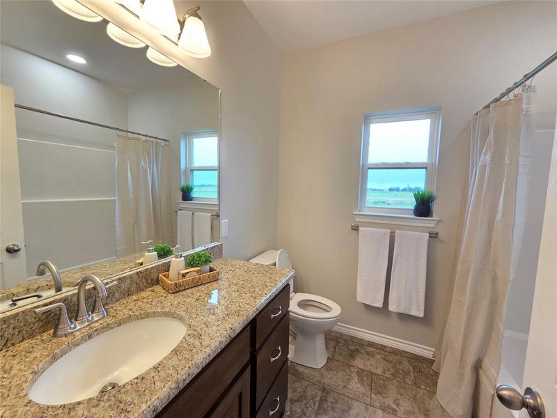 Full bath featuring vanity and a shower with curtain Full bath featuring vanity and a shower with curtain