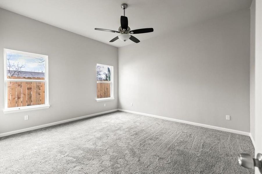 Unfurnished room featuring ceiling fan and carpet floors