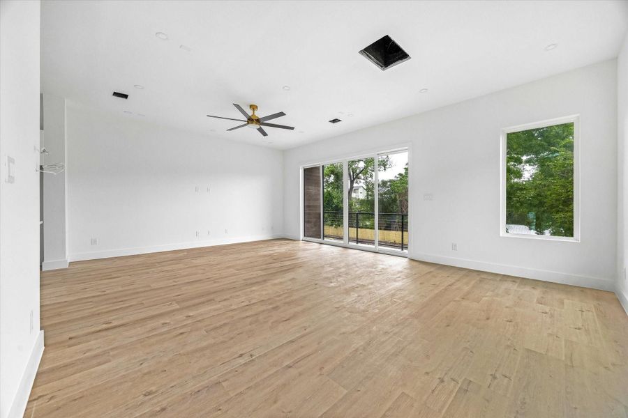 The living and dining areas are filled with natural light from expansive sliding doors and picture windows.