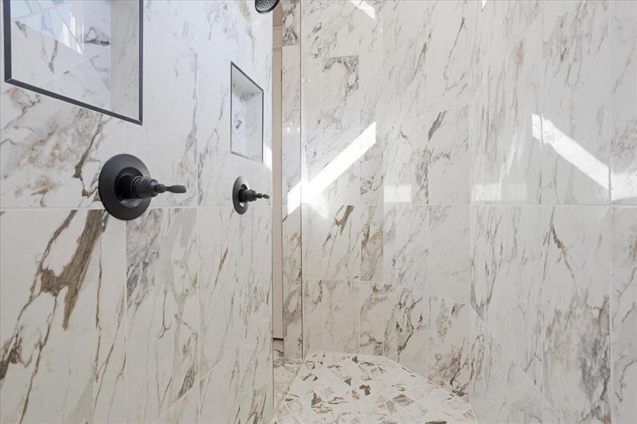 the Primary shower is a large walk through shower. Dual heads Floor to ceiling high level tile. the Primary shower is a large walk through shower. Dual heads Floor to ceiling high level tile.