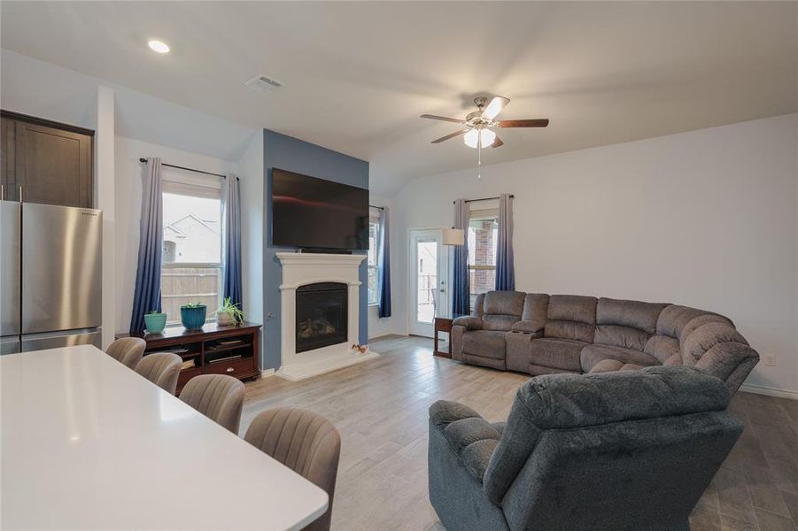 Living room featuring light hardwood / wood-style flooring, a wealth of natural light, and ceiling fan