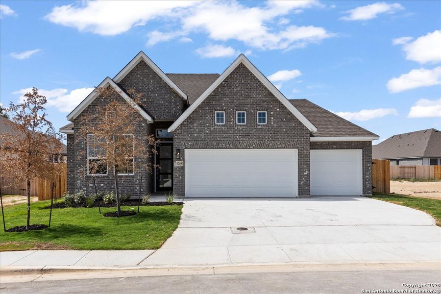 Front exterior of a new home in Village at Three Oaks, Seguin, TX, highlighting curb appeal (Image 1).