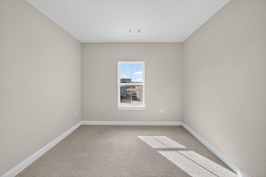 Empty room with carpet and baseboards Empty room with carpet and baseboards