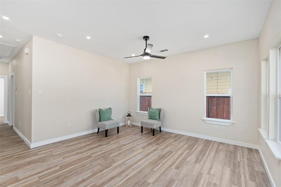 Unfurnished room with recessed lighting, light wood-style flooring, attic access, and a ceiling fan