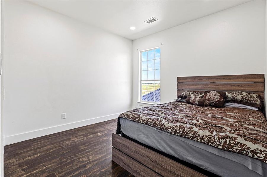 Bedroom featuring dark wood-style flooring and recessed lighting Bedroom featuring dark wood-style flooring and recessed lighting