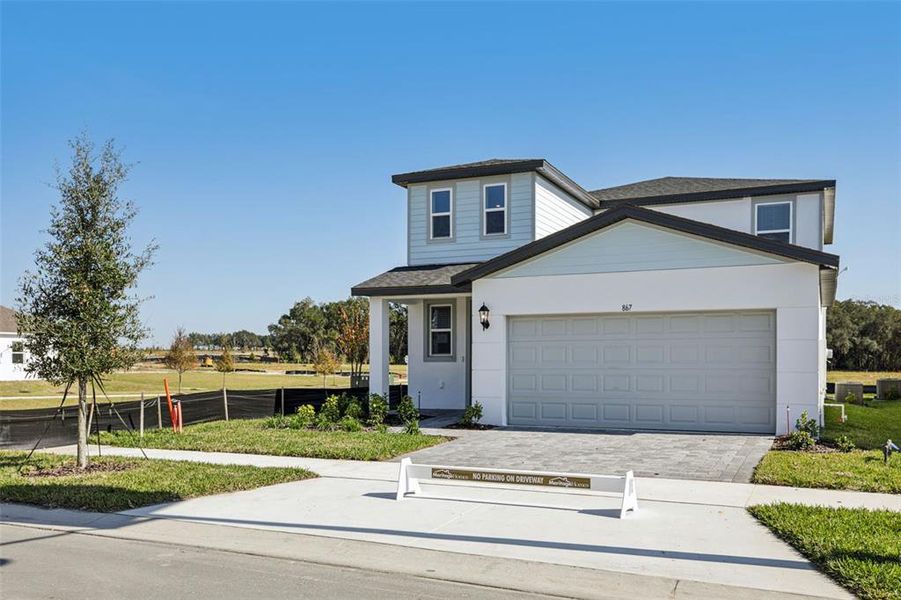Front exterior of a new home in The Reserve at Hammock Oaks - Classic Series, Lady Lake, FL, highlighting curb appeal (Image 20).