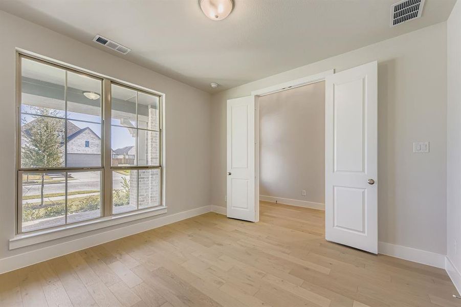 Unfurnished bedroom featuring light wood-style flooring and baseboards