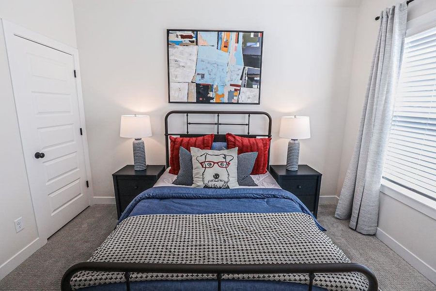 Bedroom with baseboards and carpet