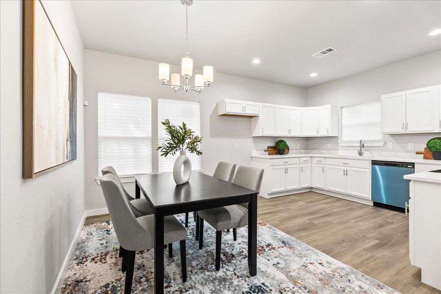 Dining room with light wood finished floors, recessed lighting, and a chandelier Dining room with light wood finished floors, recessed lighting, and a chandelier
