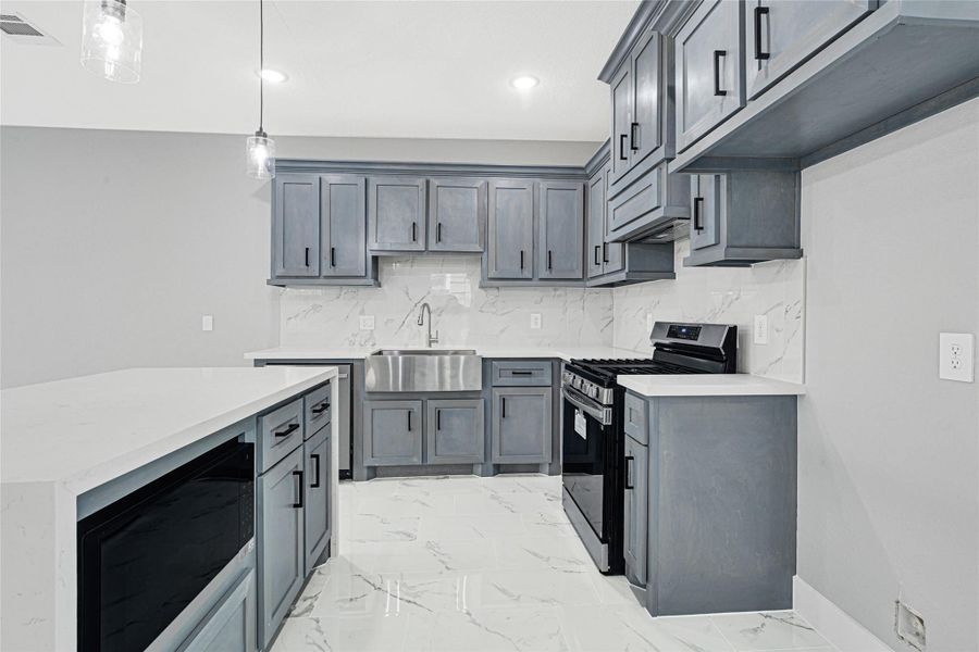 Quartz countertop in kitchen and bathrooms. Farm sink