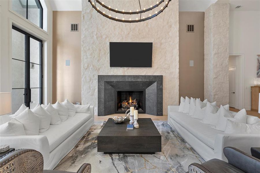 Living area with a high ceiling and a high end fireplace
