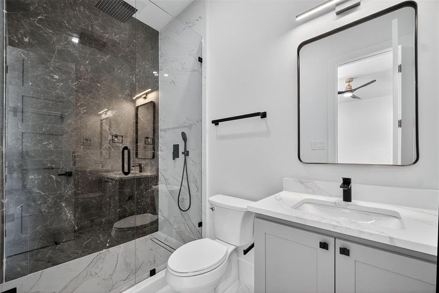 Full bath with a marble finish shower, vanity, and marble finish flooring