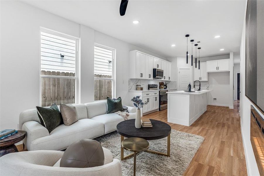 Living room with light wood-style flooring and recessed lighting Living room with light wood-style flooring and recessed lighting