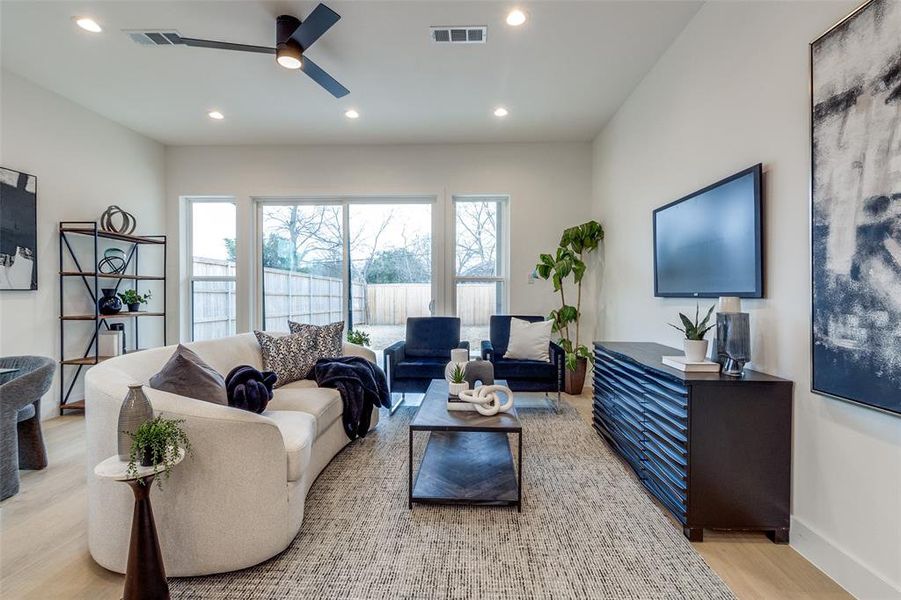 Living room featuring light hardwood / wood-style floors and ceiling fan