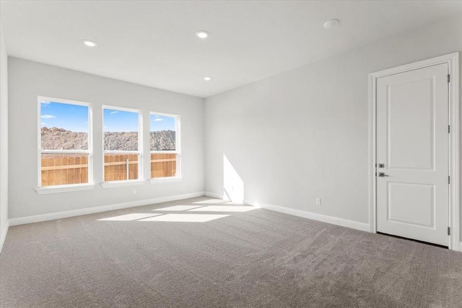 Carpeted empty room featuring recessed lighting