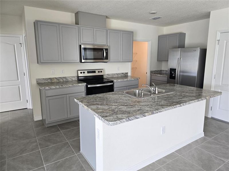 Furnished interior view inside a new home in Charles Cove Express, Davenport (Image 5).