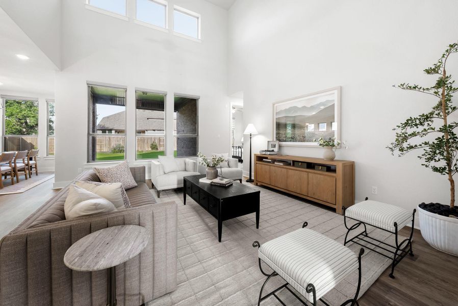 A generous living area presents high ceilings and a flowing open floorplan, perfect for modern entertaining.