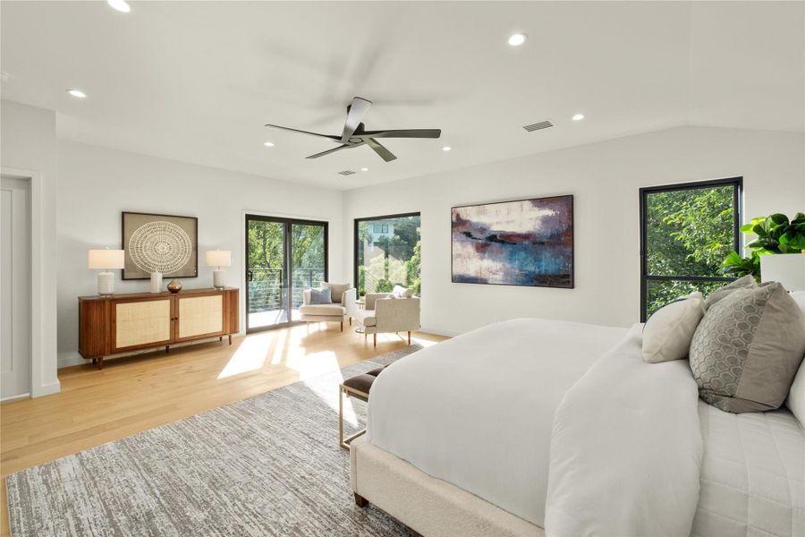 Bedroom featuring light wood-style floors, multiple windows, recessed lighting, and ceiling fan private balcony