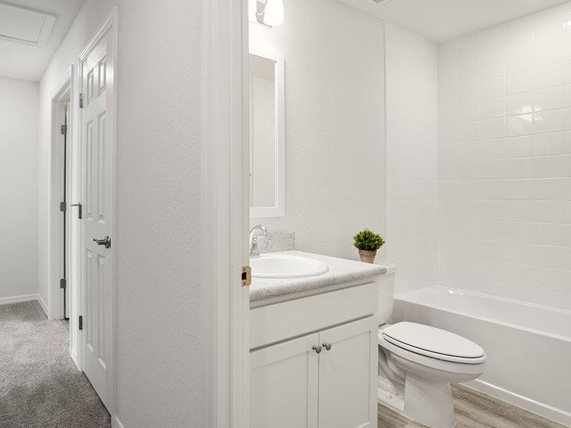 An upstairs hall bath serves bedroom 2, and this home also has a convenient downstairs powder room. An upstairs hall bath serves bedroom 2, and this home also has a convenient downstairs powder room.