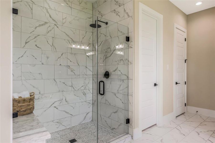 Spacious glass-enclosed shower with elegant tiles and black fixtures, creating a sleek and luxurious feel. Spacious glass-enclosed shower with elegant tiles and black fixtures, creating a sleek and luxurious feel.