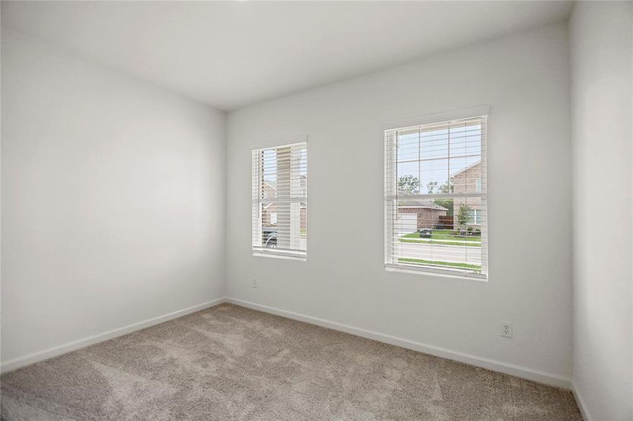 Secondary bedroom with dual windows bringing in balanced natural light.