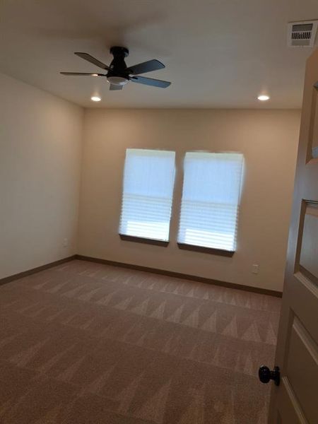 Unfurnished room with dark colored carpet, recessed lighting, and a ceiling fan Unfurnished room with dark colored carpet, recessed lighting, and a ceiling fan