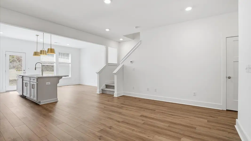 Hardwood flooring and high standards define this vibrant family room ideal for everyday living near Downtown Greenville