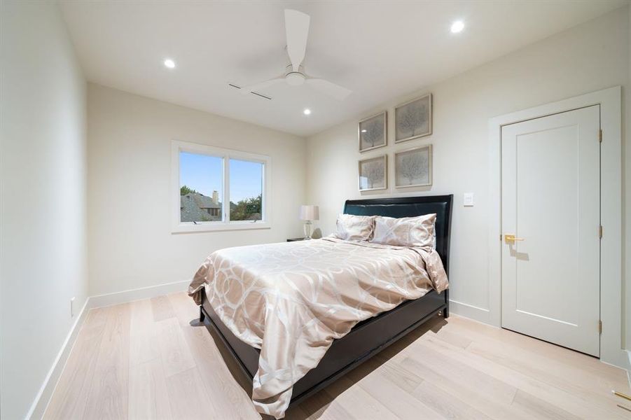 A guest bedroom upstairs offers a ceiling fan, wood flooring and large closet, plus a bath!