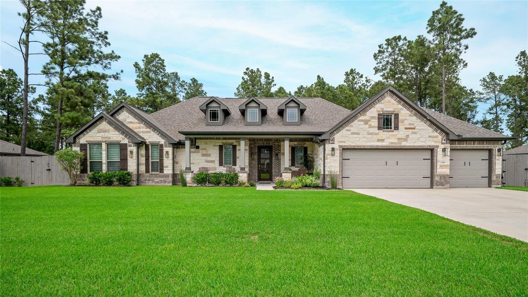 The Madison floor plan with a stone-and-brick exterior and an oversized three-car garage.