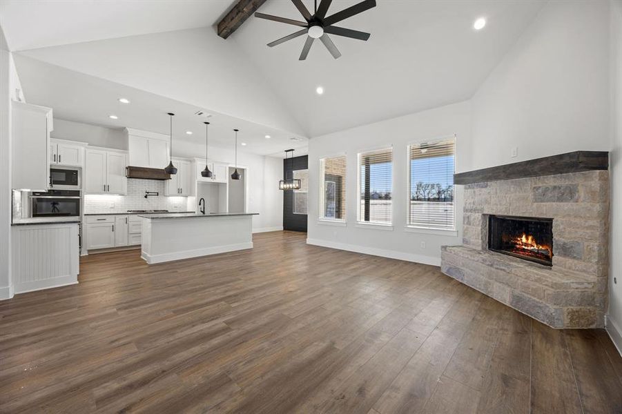 Unfurnished living room featuring recessed lighting, a fireplace, dark wood-type flooring, and ceiling fan