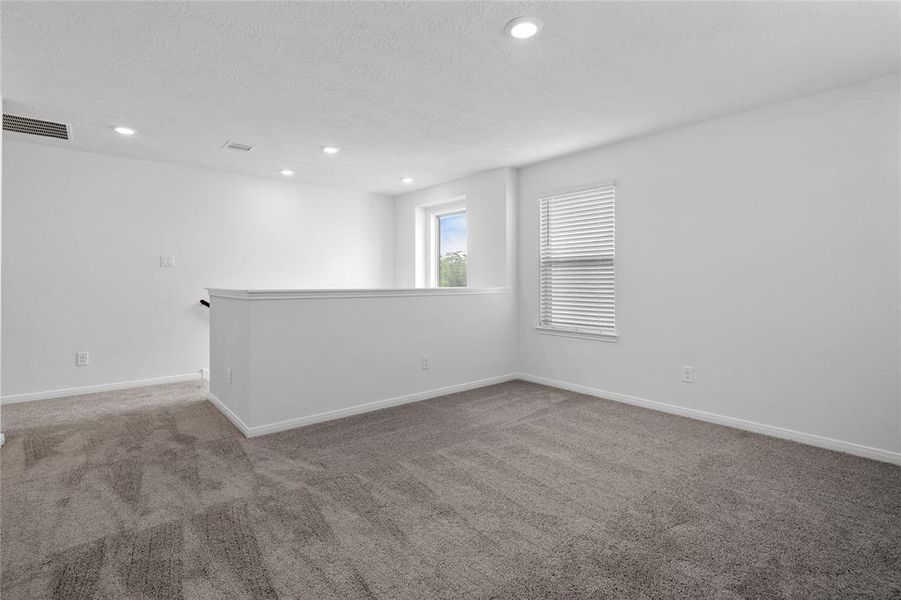 Another view of this grand size game room looking towards the staircase.