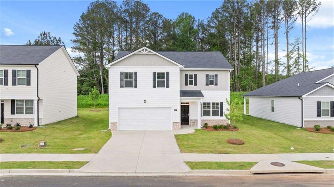 Front exterior of a new home in Poplar Preserve, Newnan, GA, highlighting curb appeal (Image 1). Front exterior of a new home in Poplar Preserve, Newnan, GA, highlighting curb appeal (Image 1).