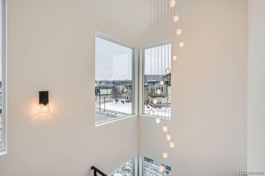 Designer chandelier hanging in atrium foyer area. View from 2nd level.