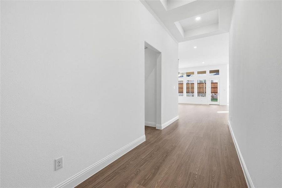 Corridor with dark wood-style floors and recessed lighting Corridor with dark wood-style floors and recessed lighting