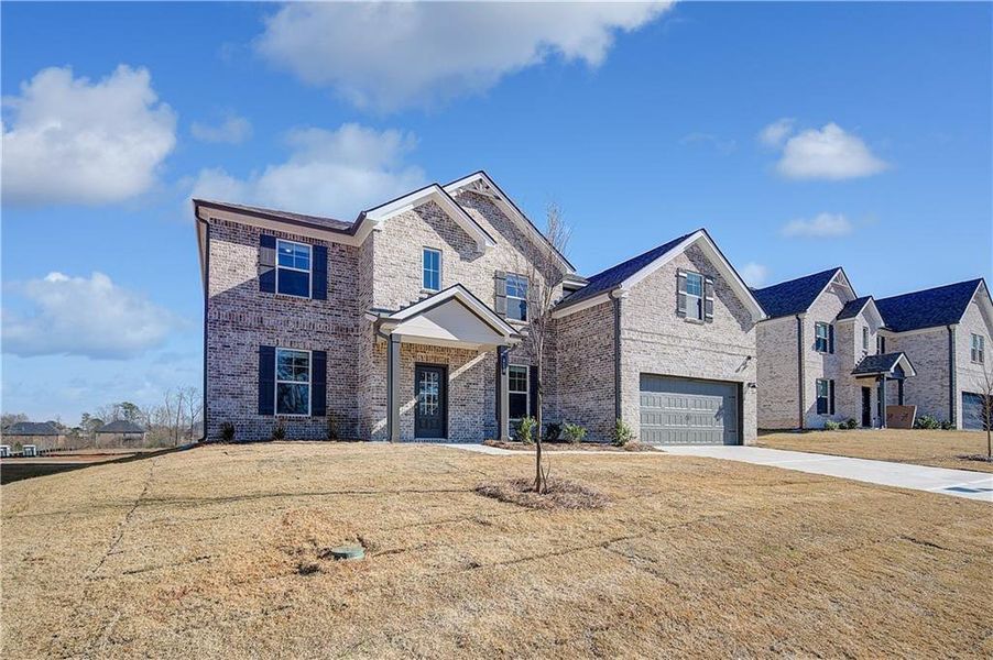 Front exterior of a new home in , Hampton, GA, highlighting curb appeal (Image 24).