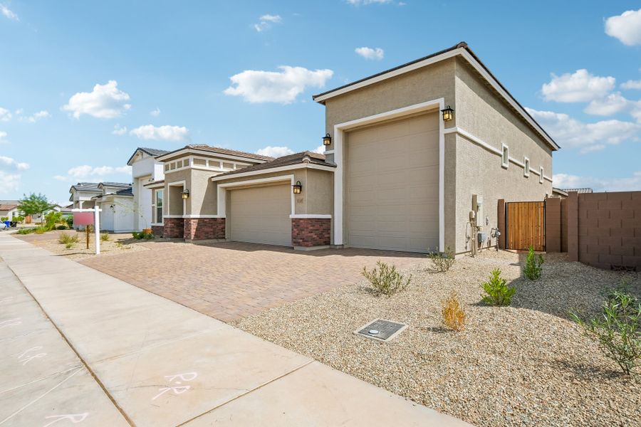 Front exterior of a new home in Artisan at Asante, Surprise, AZ, highlighting curb appeal (Image 26). Front exterior of a new home in Artisan at Asante, Surprise, AZ, highlighting curb appeal (Image 26).