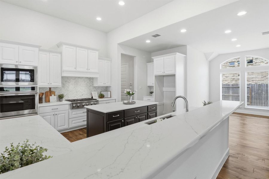 Tucked off the kitchen is a generous breakfast area bathed in natural light through arched windows, ready for slow Sunday mornings, homework sessions, and every beautiful moment in between. This is more than a kitchen. It is the heart of the home.