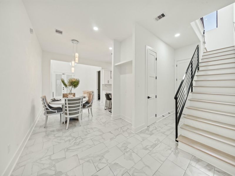 Upon entering through the front door, in view are...Ceramic Tile Flooring, Dining Room, Staircase, Hallway to Secondary Bath-room, and Utility-room