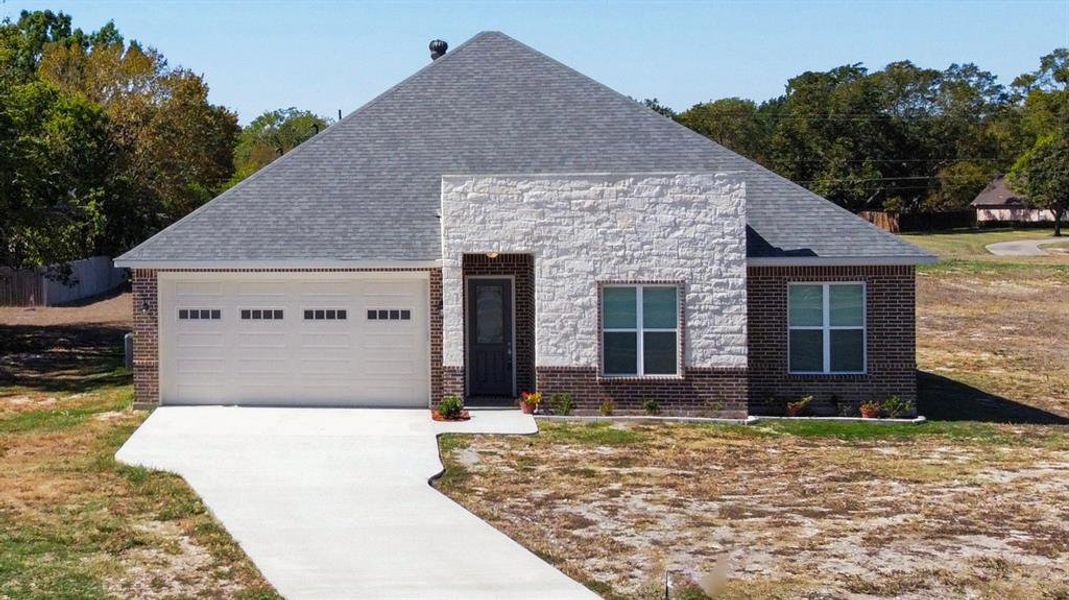 Front exterior of a new home in , Commerce, TX, highlighting curb appeal (Image 2).