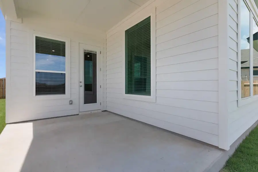 A spacious covered patio provides a delightful outdoor living extension to the home.