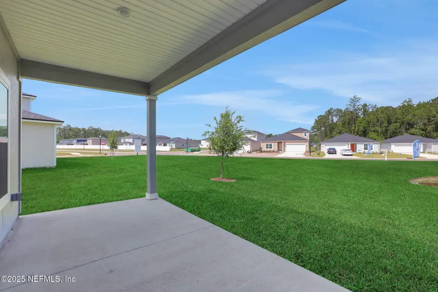 Front exterior of a new home in Amberly, Green Cove Springs, FL, highlighting curb appeal (Image 15).