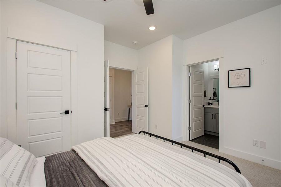 Secondary bedroom on the first floor with a private entrance through the backyard. Photos from another community by the same builder, FINISHES & FLOOR PLAN MAY VARY! Ceiling fans are not included!